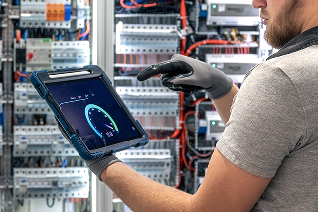Technician Using Tablet to Monitor Electrical Panel Upgrade Services