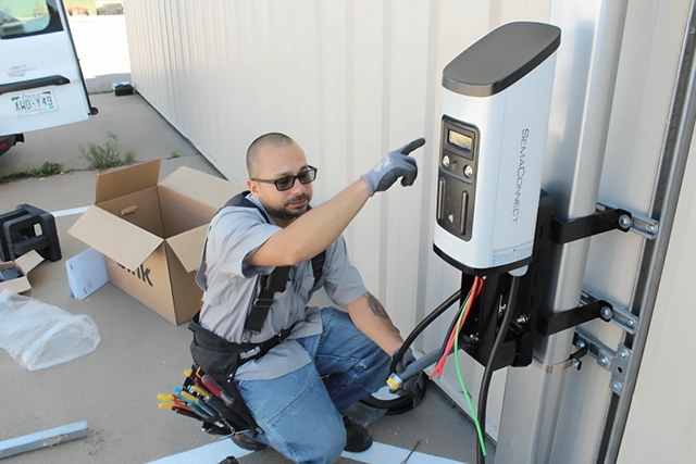 Electrician Installing EV Charger Outside a Building