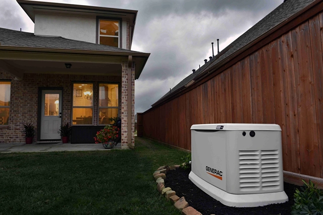Generac Generator Installed Near Wooden Fence by a Suburban Home