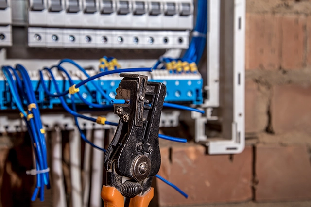 Electrician Tools and Wiring Near Electrical Panel in Lancaster, CA